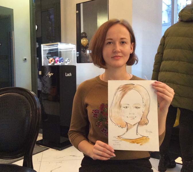 Вера позирует шаржисту Мишелю на корпоративе в магазине 